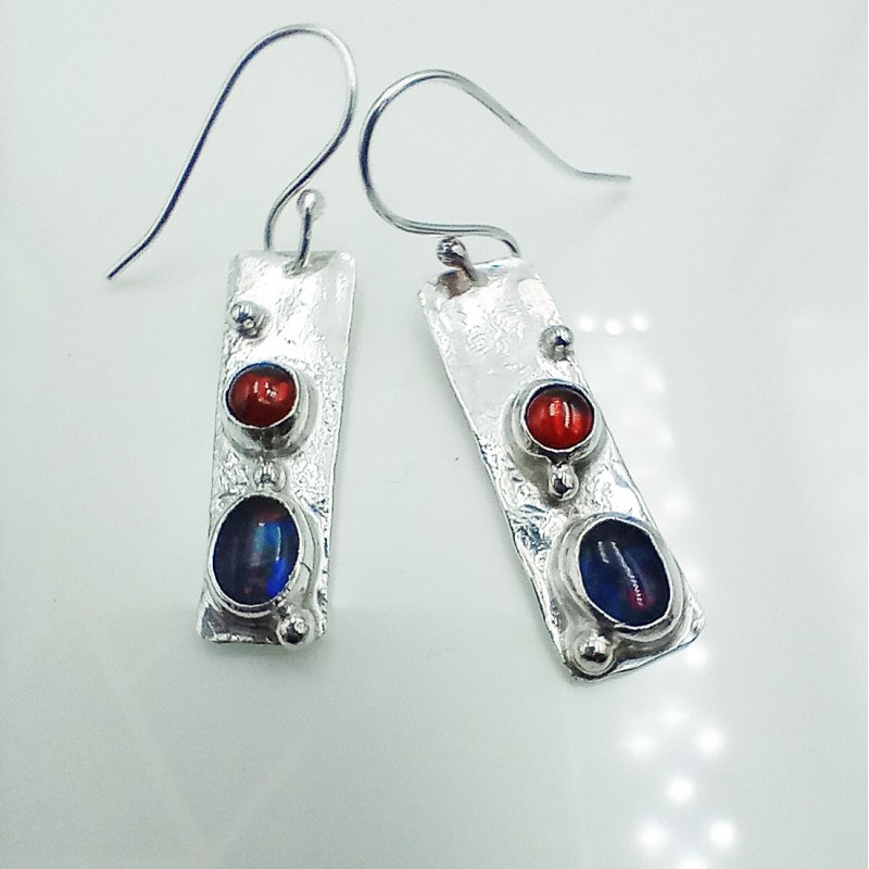 Shown set with opal and garnet